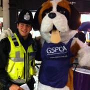 Bernard the GSPCA mascot meets a local police officer in St Peter Port, guernsey during the Christmas late night shopping